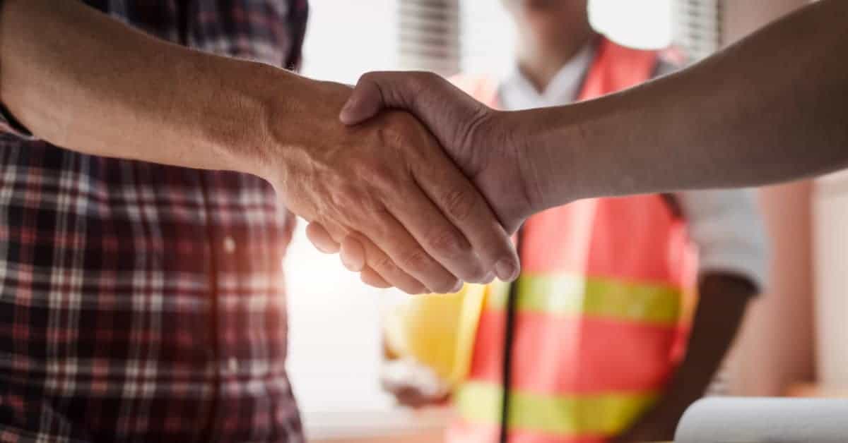 Home owner shaking hands with general contractor