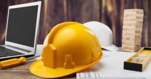 General Contractor Hard Hat on desk among other items