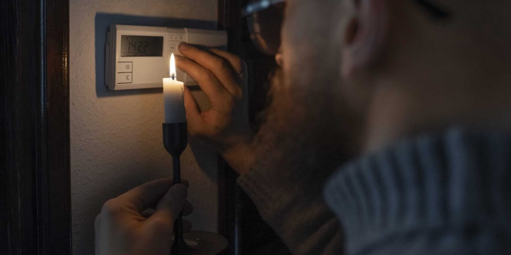 Man checking thermostat during power outage