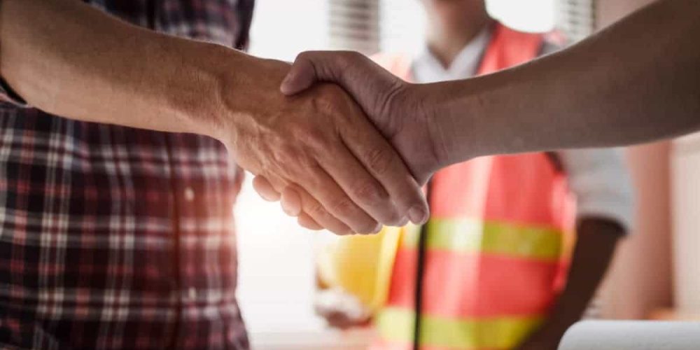 Home owner shaking hands with general contractor