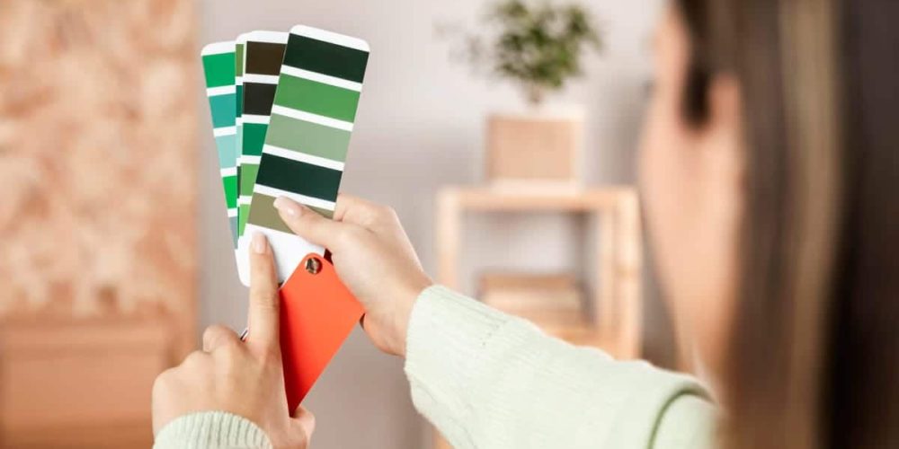 Woman picking paint from swatches