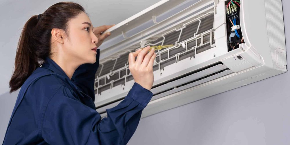 Woman maintenancing ac split unit