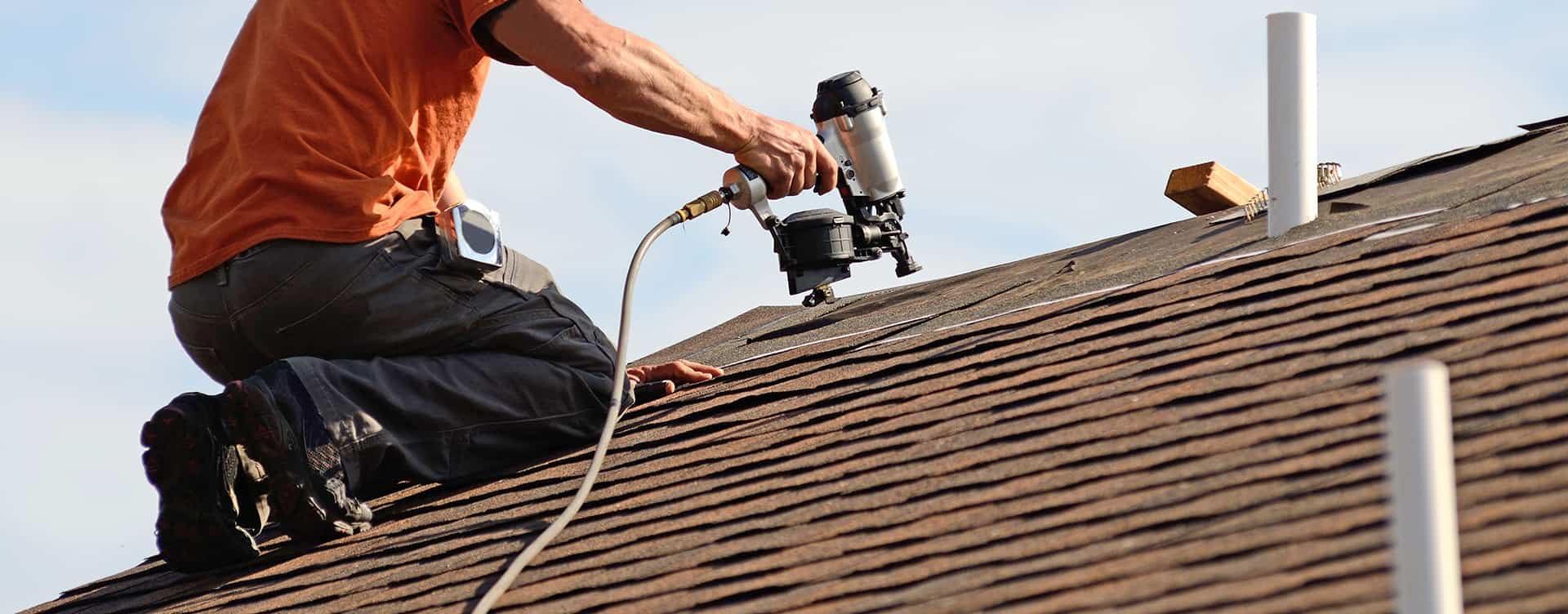 Roofing contractor repairing roof
