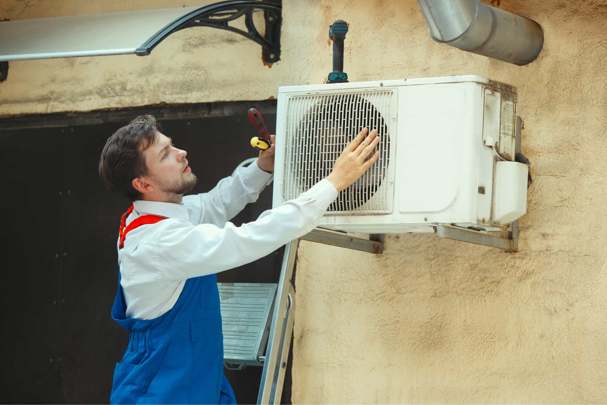 HVAC techinician performing maintenance on AC Unite