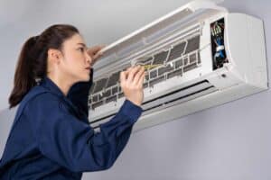 Woman maintenancing ac split unit