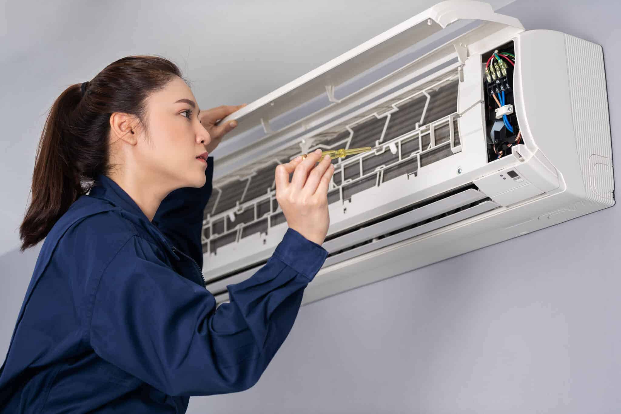 Woman maintenancing ac split unit